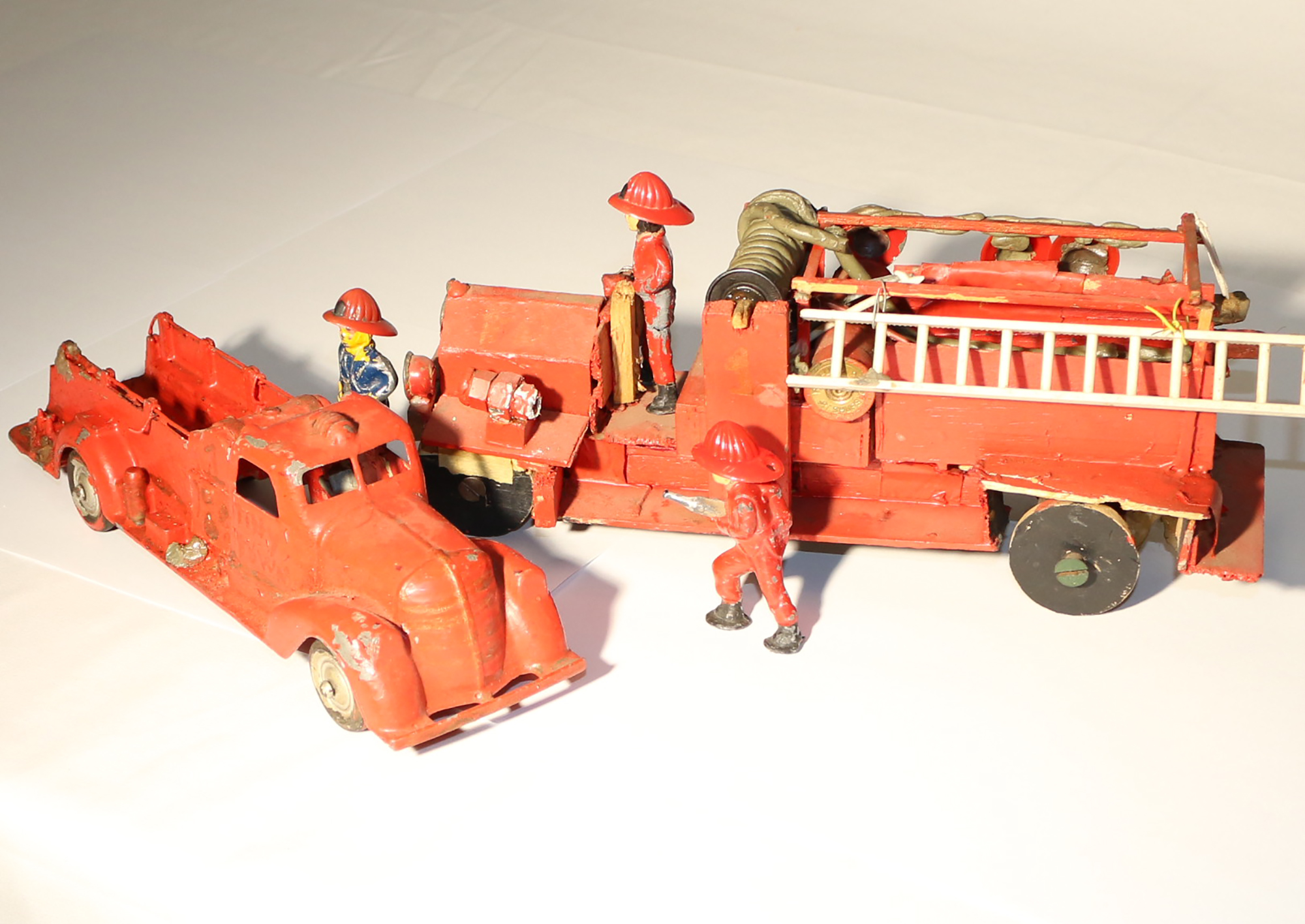 2019.32.1.1920'sEngine2 John's first engine model is flanked by scale firefighters.