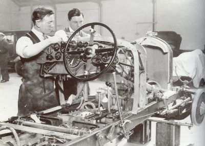 A full-size Bentley being assembled in the shop.