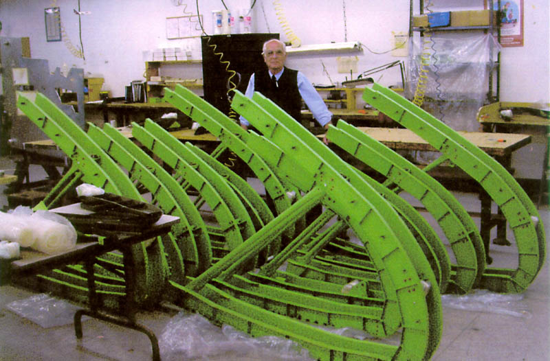 Boeing 777 Parts Gerhard stands behind several large Boeing 777 wing ribs and bulkhead parts.