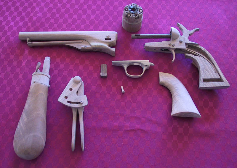 Colt Army Revolver Robert's wooden Colt Army revolver is shown disassembled.