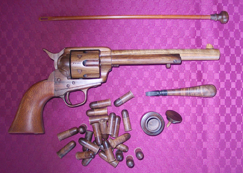 Colt Peacemaker Revolver A Colt Peacemaker revolver with carved wooden bullets.