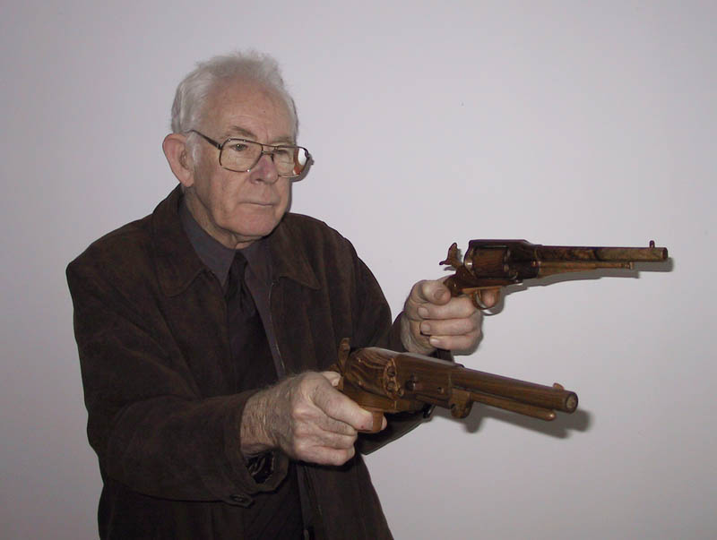 Robert A. Talbot Robert A. Talbot holding two of his wooden model revolvers.