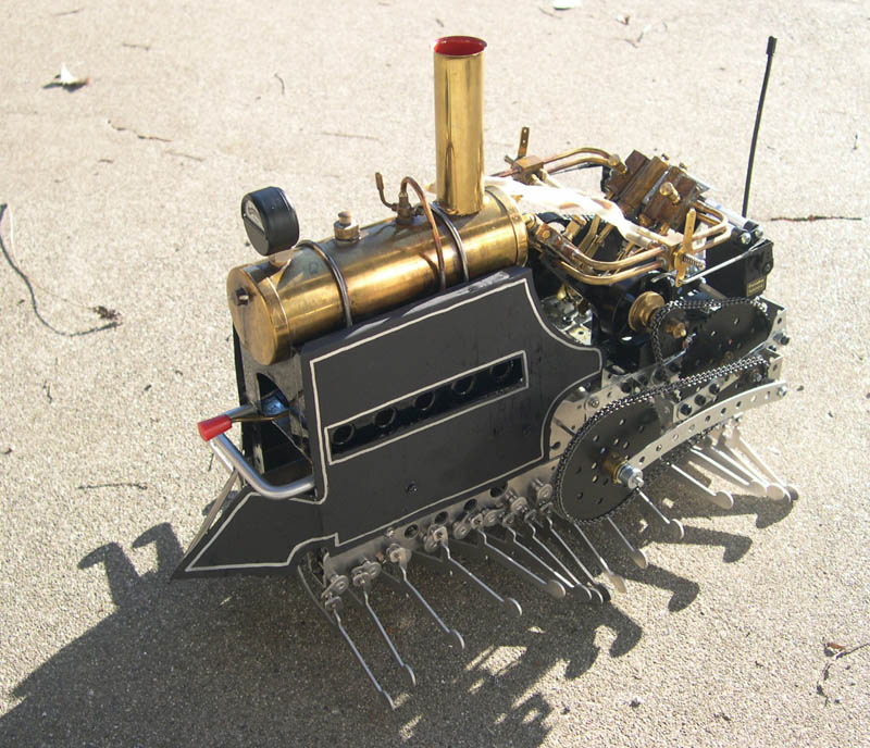 Steam LocoCentipede A steam locomotive with centipede drive mechanism works its way down the sidewalk.