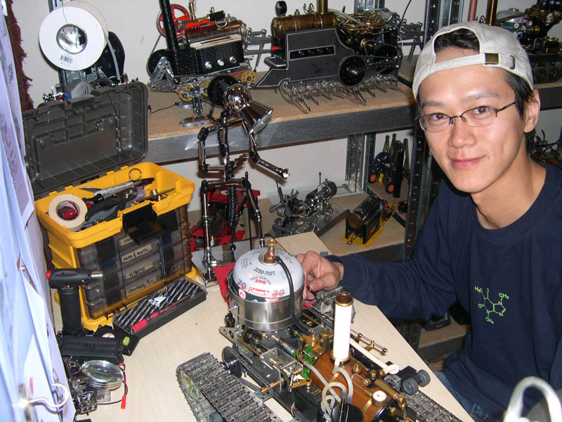 I-Wei at His Desk I-Wei at his desktop with some of his mechanical creations.