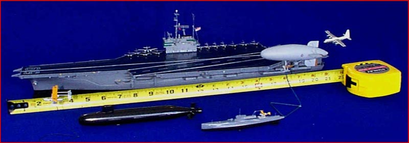 1/600 Scale Ships A ruler demonstrates the size difference between various models, from an aircraft carrier to submarines.