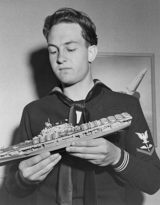 Bill With a Model Ship Bill in his Navy uniform with a scale model aircraft carrier.