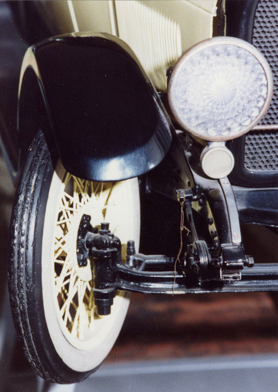 1/4 Scale Marmon 34 Coupe A close-up of a headlight and the front suspension on the 1/4 scale Marmon Coupe.