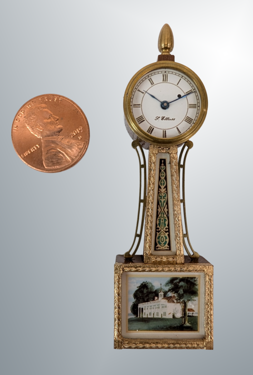 Banjo Clock Miniature Banjo Clock. Materials: Black walnut case, brass bezel, finial and side arms. Gold painted twisted rope moldings and corner blocks. Imitation reverse painted glass tablets. .9x2.75x.4